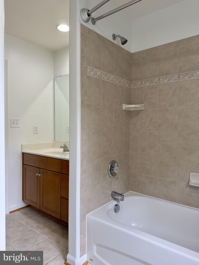 bathroom with shower / bath combination, tile patterned flooring, vanity, and baseboards