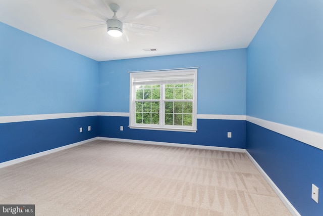 unfurnished room featuring carpet flooring, a ceiling fan, and baseboards