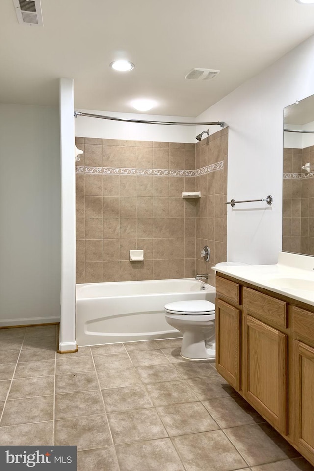 bathroom with bathing tub / shower combination, tile patterned flooring, toilet, and vanity
