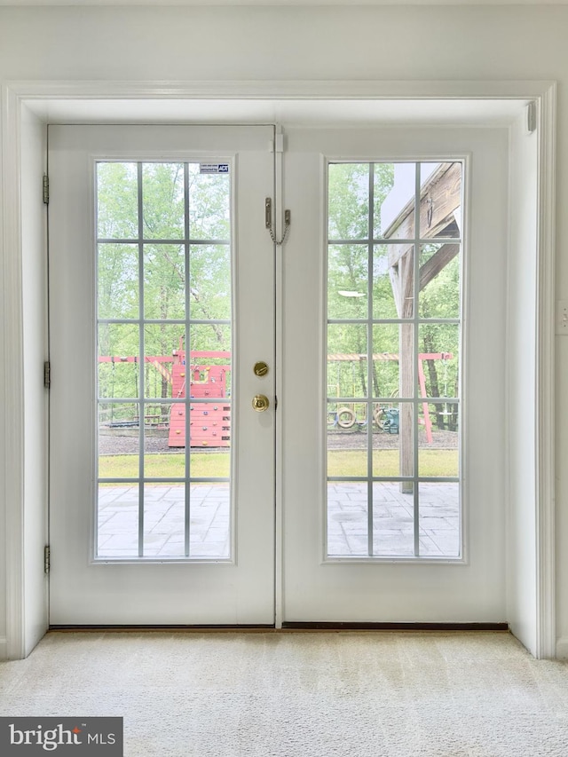 doorway featuring carpet floors