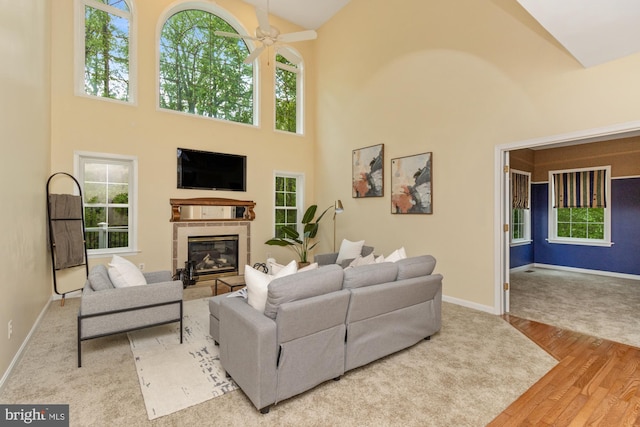 2200 Exeter Ct, Fallston, MD 21047 - living area with high vaulted ceiling, wood finished floors, a glass covered fireplace, a ceiling fan, and healthy amount of natural light