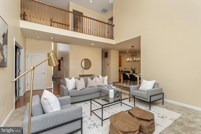 2200 Exeter Ct, Fallston, MD 21047 - living room with a high ceiling, a chandelier, baseboards, light colored carpet, and stairway