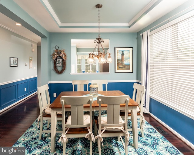 31766 Chablis Ln Unit 76, Lewes, DE 19958 - dining area featuring dark wood-style floors, a chandelier, crown molding, a raised ceiling, and wainscoting