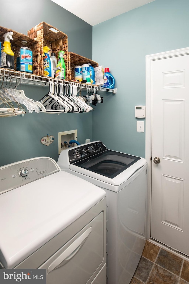 31766 Chablis Ln Unit 76, Lewes, DE 19958 - laundry area with washer and dryer and dark stone finish flooring