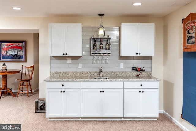31766 Chablis Ln Unit 76, Lewes, DE 19958 - kitchen with a sink, baseboards, white cabinets, light colored carpet, and recessed lighting