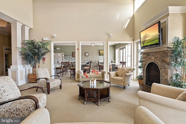 31766 Chablis Ln Unit 76, Lewes, DE 19958 - carpeted living room with decorative columns, a high ceiling, a fireplace, and ceiling fan