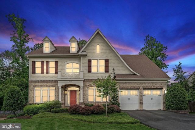 view of front of home featuring asphalt driveway, a lawn, brick siding, a shingled roof, and an attached garage