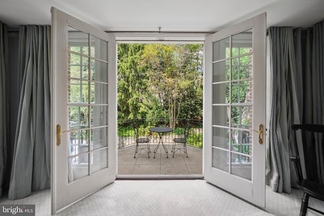 doorway featuring plenty of natural light and tile patterned flooring