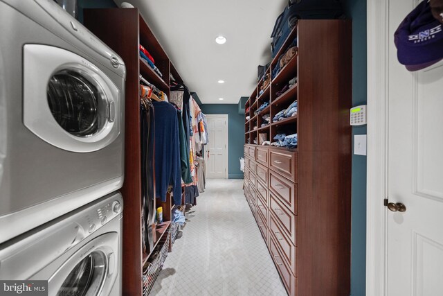 laundry room featuring stacked washer / dryer, recessed lighting, and light colored carpet