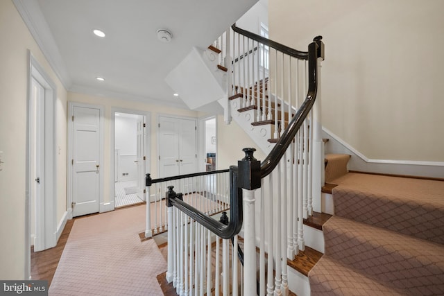 stairway featuring recessed lighting, baseboards, wood finished floors, and crown molding
