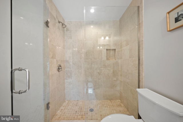 full bathroom with toilet and a shower stall