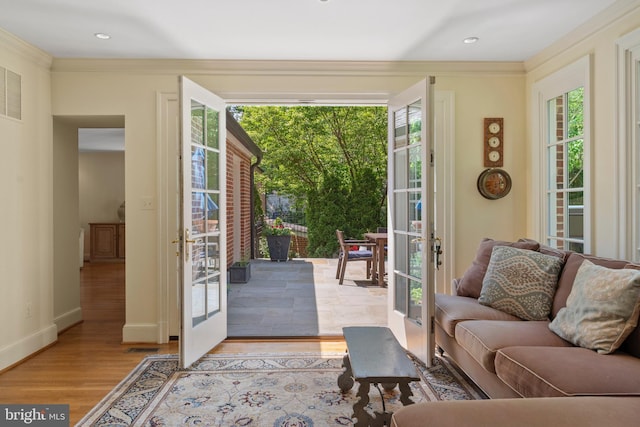 living area with french doors, wood finished floors, crown molding, baseboards, and recessed lighting