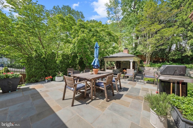 view of patio / terrace featuring a gazebo, outdoor dining space, area for grilling, and fence