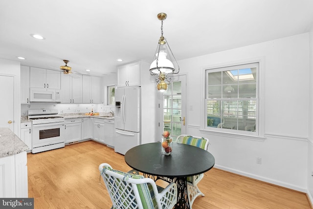 7607 Newcastle Dr, Annandale, VA 22003 - kitchen featuring white appliances, light wood-style floors, healthy amount of natural light, and recessed lighting