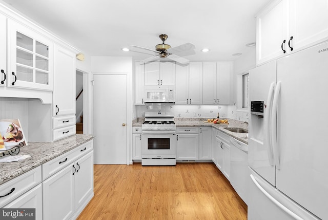 7607 Newcastle Dr, Annandale, VA 22003 - kitchen with white appliances, a sink, white cabinets, light wood-style floors, and a ceiling fan