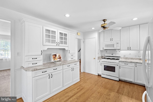 7607 Newcastle Dr, Annandale, VA 22003 - kitchen with white appliances, white cabinets, light wood-style flooring, ceiling fan, and recessed lighting