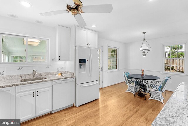 7607 Newcastle Dr, Annandale, VA 22003 - kitchen featuring white appliances, a sink, white cabinets, light wood-type flooring, and recessed lighting