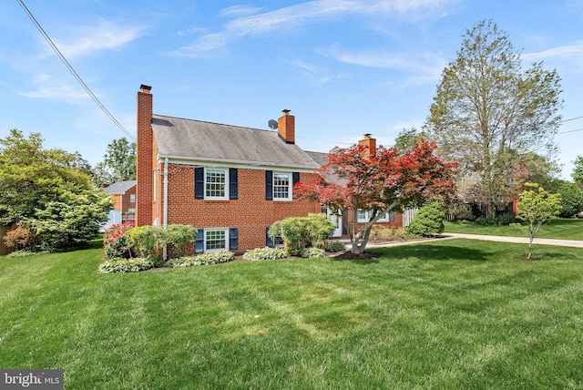 7607 Newcastle Dr, Annandale, VA 22003 - view of front facade with brick siding, a chimney, and a front lawn