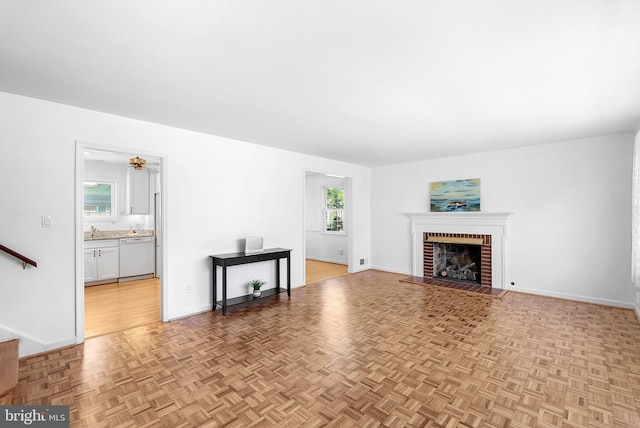 7607 Newcastle Dr, Annandale, VA 22003 - living room featuring a brick fireplace, ceiling fan, and baseboards