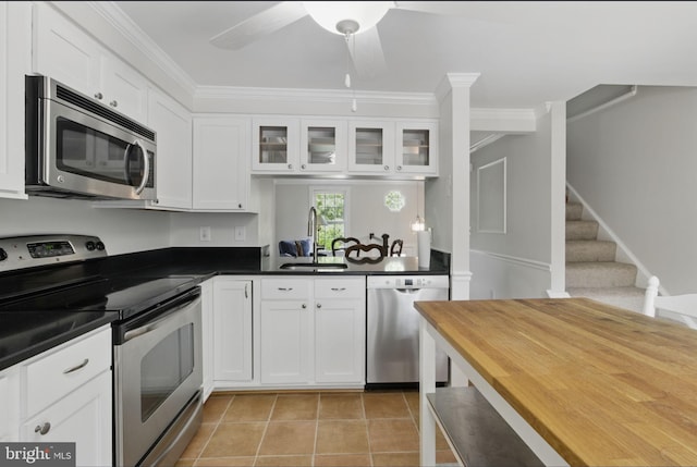 1920 Belmont Ridge Ct, Reston, VA 20191 - kitchen featuring appliances with stainless steel finishes, a sink, ornamental molding, glass insert cabinets, and a ceiling fan