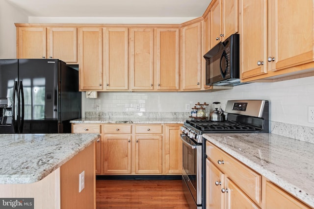 kitchen with black appliances, light brown cabinetry, dark wood-style floors, and backsplash