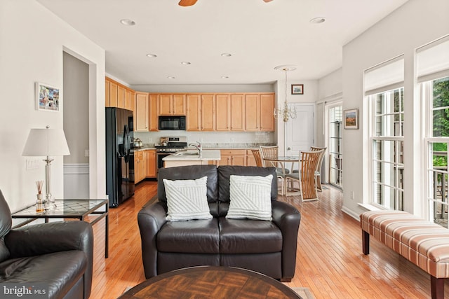 living room featuring light wood finished floors and recessed lighting