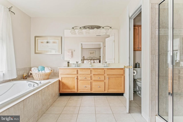 full bath with tile patterned floors, toilet, a shower stall, double vanity, and a garden tub