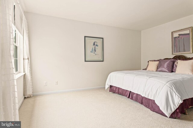 bedroom featuring carpet and baseboards