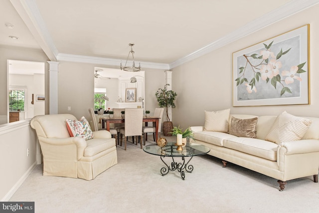 living area featuring ornamental molding, carpet floors, ceiling fan, decorative columns, and baseboards