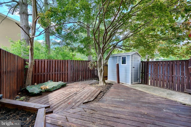 8838 Cross Country Pl, Gaithersburg, MD 20879 - wooden deck with a storage shed, a fenced backyard, and an outbuilding
