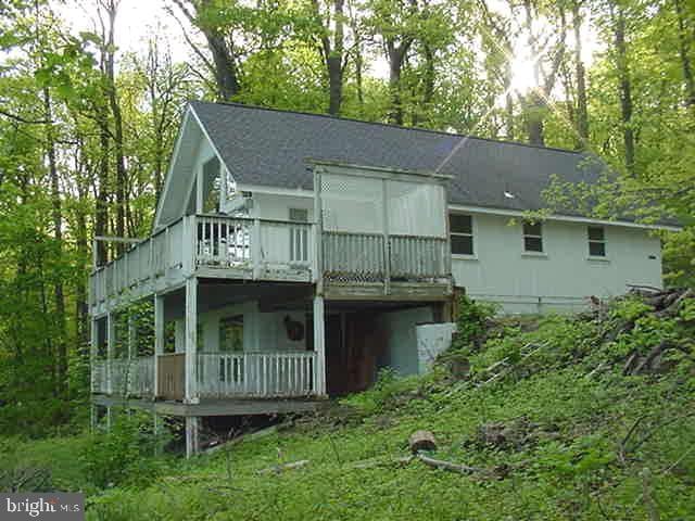 back of house featuring a wooden deck