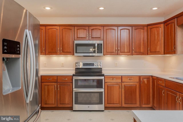 2799 Greenway Ct, Rockingham, VA 22802 - kitchen featuring stainless steel appliances, brown cabinets, light countertops, and recessed lighting