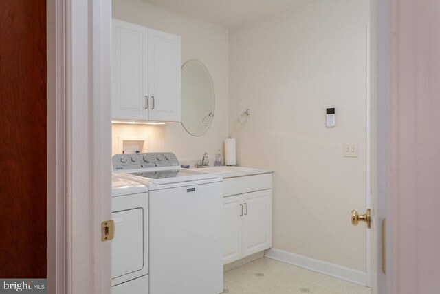 2799 Greenway Ct, Rockingham, VA 22802 - clothes washing area featuring washing machine and dryer, baseboards, and cabinet space