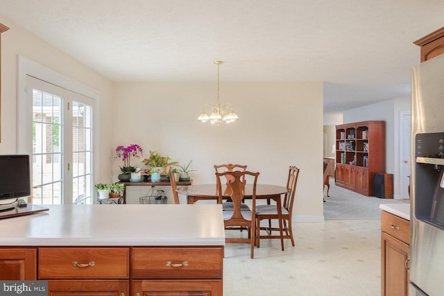 2799 Greenway Ct, Rockingham, VA 22802 - kitchen featuring light countertops, a chandelier, hanging light fixtures, and brown cabinets