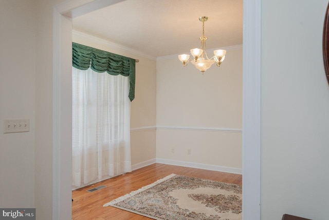 2799 Greenway Ct, Rockingham, VA 22802 - unfurnished room with a chandelier, wood finished floors, crown molding, and baseboards