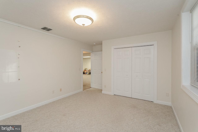 2799 Greenway Ct, Rockingham, VA 22802 - unfurnished bedroom with carpet, baseboards, a closet, and a textured ceiling