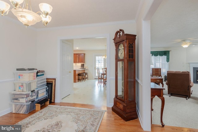 2799 Greenway Ct, Rockingham, VA 22802 - entryway with a fireplace, a chandelier, crown molding, light wood finished floors, and baseboards