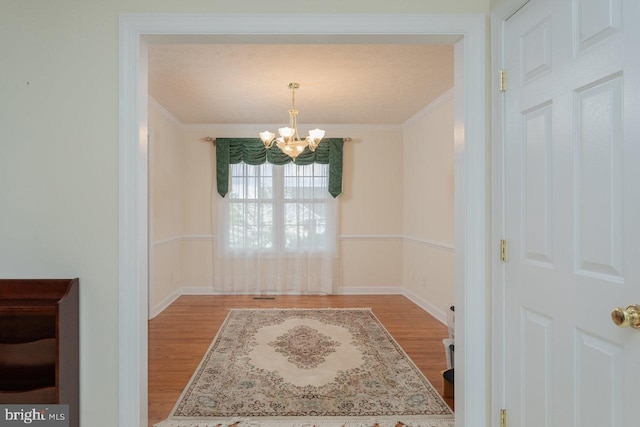 2799 Greenway Ct, Rockingham, VA 22802 - unfurnished dining area with a chandelier, wood finished floors, crown molding, and baseboards