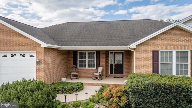 2799 Greenway Ct, Rockingham, VA 22802 - property entrance with brick siding, an attached garage, and a shingled roof
