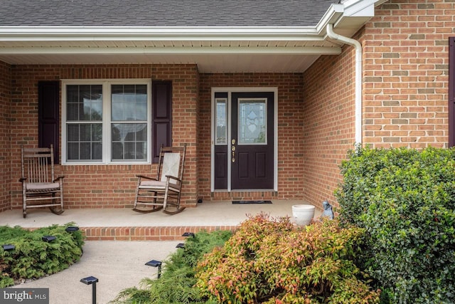 2799 Greenway Ct, Rockingham, VA 22802 - entrance to property featuring a shingled roof, brick siding, and covered porch