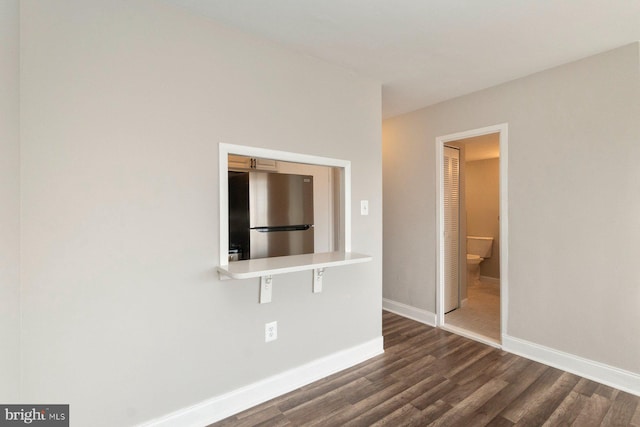 922 24th St NW Unit 806, Washington, DC 20037 - spare room with dark wood-type flooring and baseboards