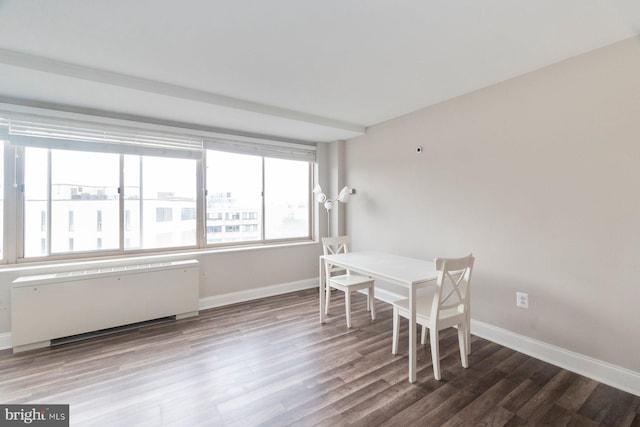 922 24th St NW Unit 806, Washington, DC 20037 - dining area with radiator, wood finished floors, and baseboards