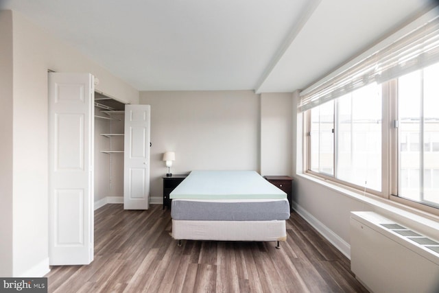 922 24th St NW Unit 806, Washington, DC 20037 - bedroom featuring baseboards, wood finished floors, and a closet