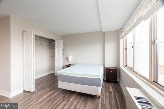 922 24th St NW Unit 806, Washington, DC 20037 - bedroom with baseboards, wood finished floors, and a closet