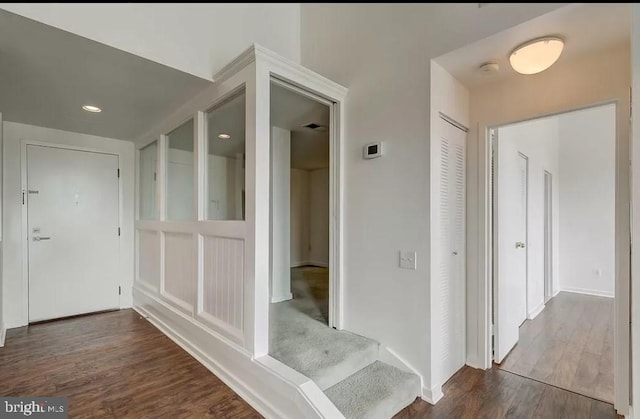 hallway with wood finished floors, baseboards, and recessed lighting