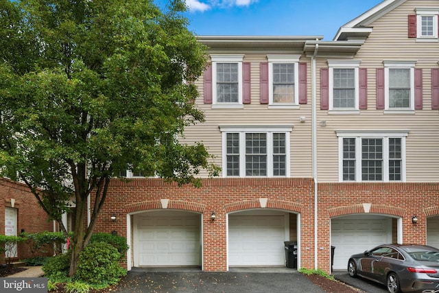7135 Huntley Creek Pl Unit 55, Alexandria, VA 22306 - townhome / multi-family property featuring an attached garage, driveway, and brick siding