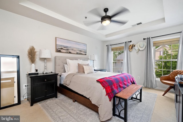 7135 Huntley Creek Pl Unit 55, Alexandria, VA 22306 - bedroom featuring a tray ceiling, light colored carpet, and a ceiling fan