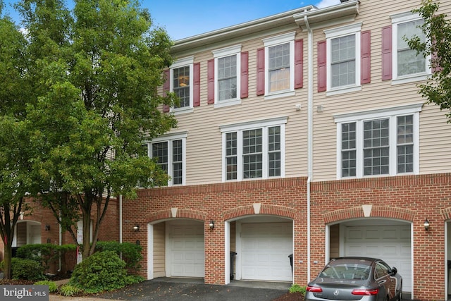 7135 Huntley Creek Pl Unit 55, Alexandria, VA 22306 - townhome / multi-family property with driveway, a garage, and brick siding