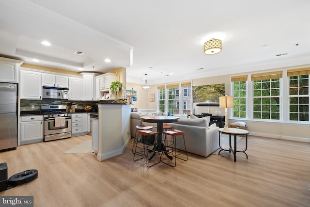 7135 Huntley Creek Pl Unit 55, Alexandria, VA 22306 - kitchen with stainless steel appliances, dark countertops, light wood-style flooring, recessed lighting, and crown molding