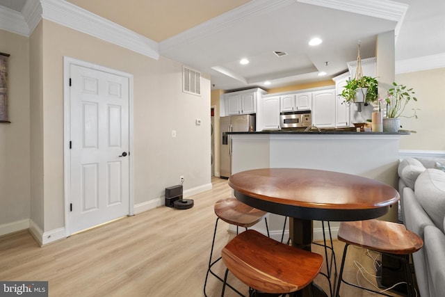 7135 Huntley Creek Pl Unit 55, Alexandria, VA 22306 - dining area featuring light wood-style flooring, baseboards, recessed lighting, a raised ceiling, and crown molding
